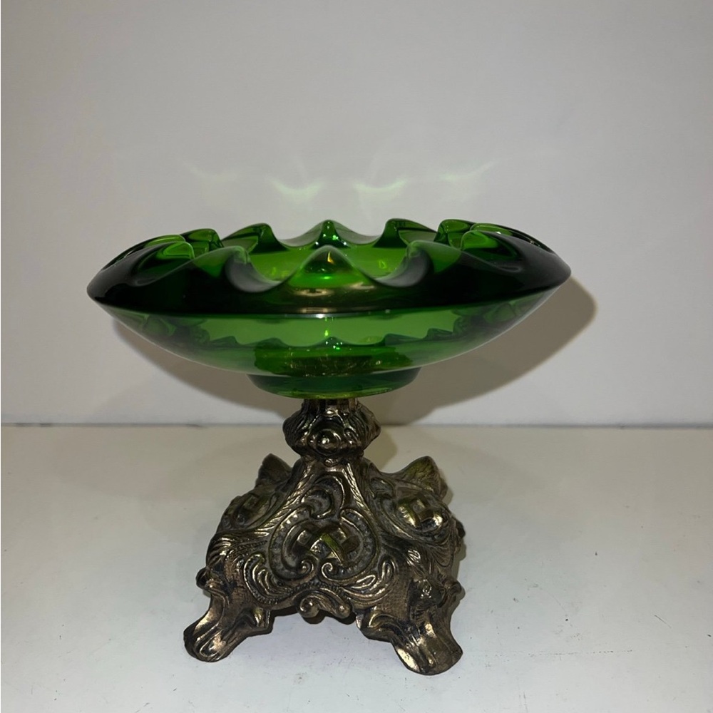 vintage green glass ashtray with an ornate metal base